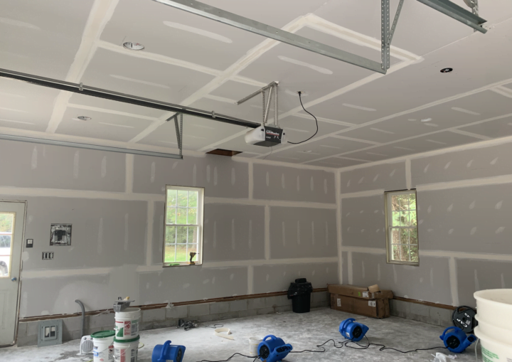 An indoor garage space primed and ready for painting