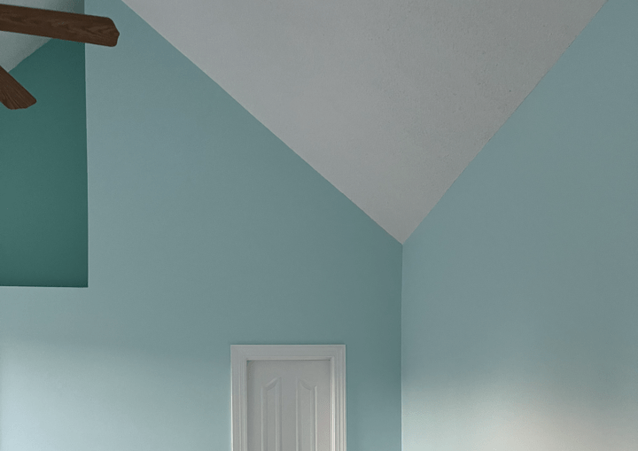 A room with light blue walls and a white door