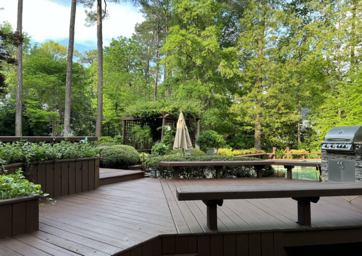 A freshly painted wooden deck and bench in matching brown color