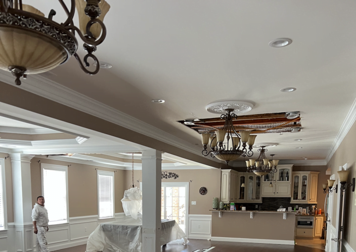 A living room with tan walls and white accents after being painted