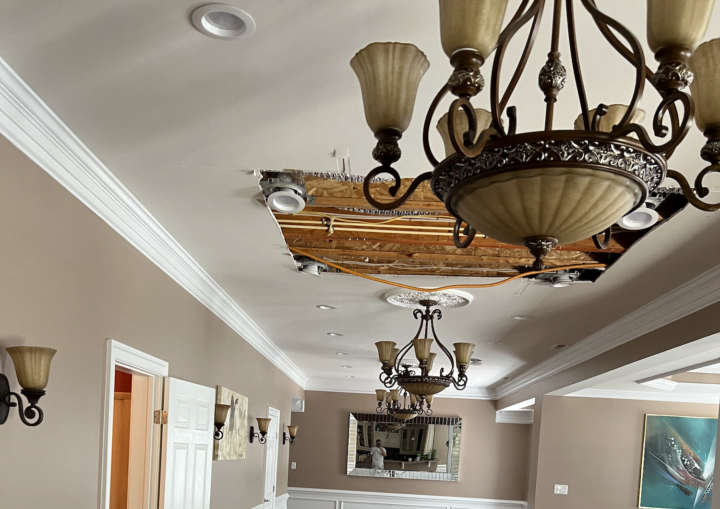 A living room with tan walls and white accents after being painted