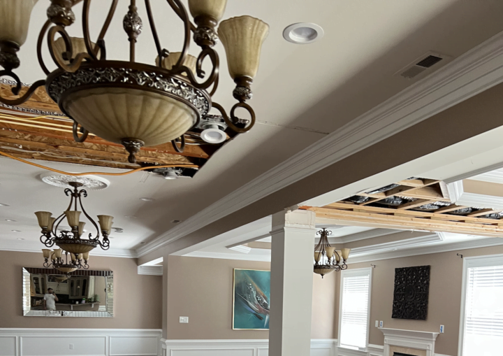 A living room with tan walls and white accents after being painted