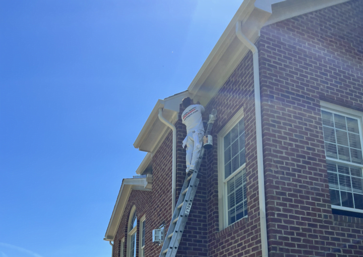 A brick house with trim framed by painters' tape