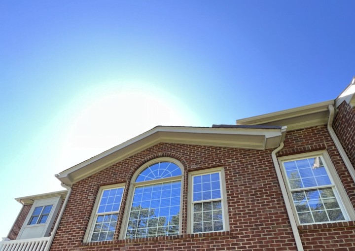 A brick house with trim framed by painters' tape