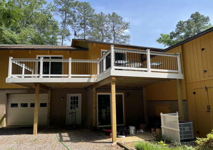 The outside of a freshly painted, modern house in a goldenrod color