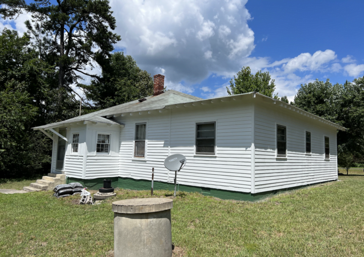 A white house with green trim