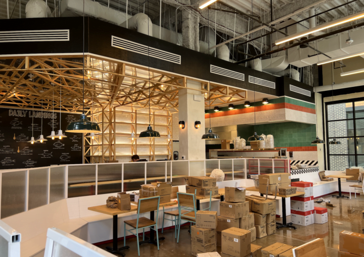 The interior of a modern, commercial restaurant with black, green, red, and white paint